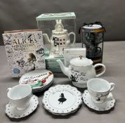 A selection of Alice in Wonderland memorabilia to include teapot, saucers and cups