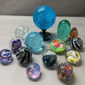 A selection of glass paperweights, various makers, styles and sizes.
