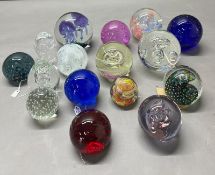 A selection of glass paperweights, various makers and styles