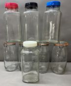 A selection of glass storage jars some with glass lids and plastic screw tops