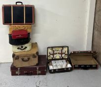 A selection of vintage suitcases and picnic hampers