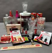 A bundle of new and vintage Coca Cola memorabilia to include glasses, lighters and ice box