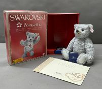A Boxed Steiff Swarovski Poinsette Teddy Bear boxed with crystal ornament and certificates.