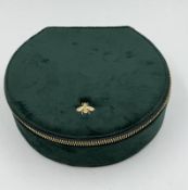 Dark Green velvet jewellery box with gold coloured bee logo.