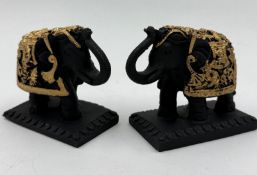A pair of black and gold elephant bookends