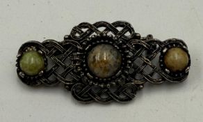 A Celtic three-stone brooch