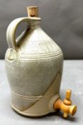 A Studio Pottery stoneware flagon with tap and corked top.