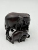 A carved herd of elephants ornament