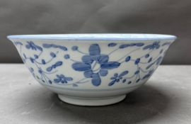 A Chinese blue and white bowl in a floral pattern, signed to base