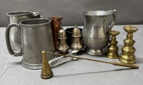 A quantity of mixed metal items to include pewter tankards, a copper jug and brass candlesticks