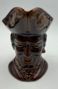 A vintage brown ground glazed toby jug