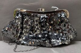 A silver-toned sequin clutch bag