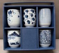 A boxed set of blue and white tea cups