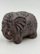 A ceramic elephant, dusty mauve.