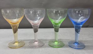 A set of four uranium glass globlets in green, orange, pink and blue