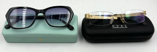 A pair of Ray Ban rimless glasses and a pair of Tom Archer sunglasses