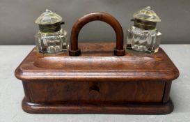 An Edwardian double inkwell and desk tidy with drawers under