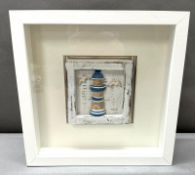 A boxed framed contemporary lighthouse picture.