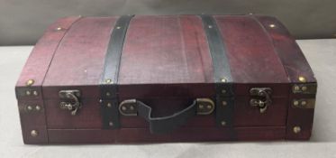 A brown wooden leather banded case with brass stud details