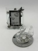 A Butterfly detail photo frame and a decorative crystal swan on glitter mirror base