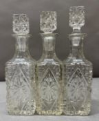 A set of three pressed glass decanters