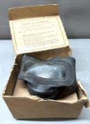 A WWII gas mask in original box