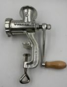 A vintage cast iron meat grinder