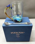 A Heavily decorated glass tankard with spoon, original box, as new.