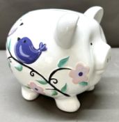 A very large piggy bank with floral decoartion