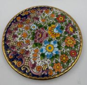 A decorative Spanish wall hanging plate with floral design