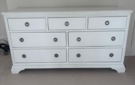 A John Lewis white chest of drawers consisting of three over four drawers with chrome effect handles