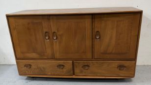 An Ercol Windsor sideboard comprising of two cupboards over two long drawers H76cm W130cm D50cm