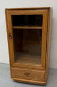 An Ercol Windsor Hi-Fi unit with glazed door and drawer under H100cm W50cm D48cm