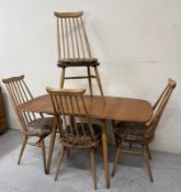 An Ercol drop leaf dining table and four Ercol Goldsmith moustache chairs H71cm W136cm D73cm