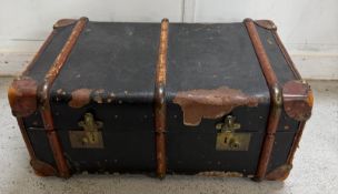 A wooden, brass and leather banded trunk