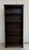 A four shelf dark stained pine bookcase H192cm W85cm D32cm