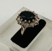 An 18ct gold set sapphire and diamond cluster ring, approximate weight 5.8g and size L
