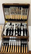 A vintage Sheffield plate cutlery canteen housed in an oak wooden box with a lower drawer