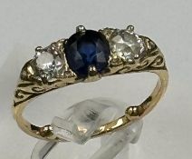 A Sapphire ring with diamonds either size, on an 18ct gold setting, size K