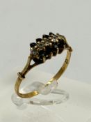 A 9ct gold ring with diamond and sapphires, approximate weight 1.7g and size Q.5