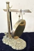 A Victorian brass dinner gong, resembling a road sign