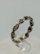 A diamond eternity style white gold ring, not hallmarked, approximate weight 2.3g and size N