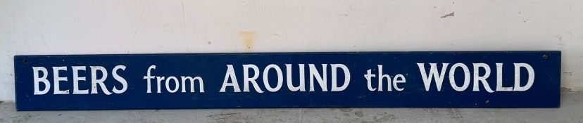 A vintage blue wooden adverting sign for “Beers From Around The World” 180x22
