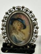An antique miniature portrait hand painted silver brooch and signed SOV