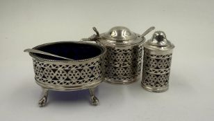A Roberts and Belk three-piece cruet set with blue glass liners, Sheffield 1921 together with two