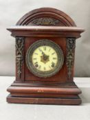A mahogany cased eight day mantel clock with an enamel face and Roman numerals
