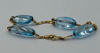 A four blue stone gold bracelet, marked 750, approximate total weight 10.2g