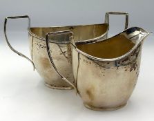 A hallmarked silver sugar bowl and milk jug by Deakin & Francis Ltd Birmingham 1921, approximate