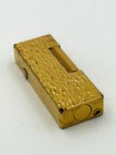 A Dunhill lighter with bark effect.