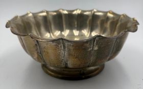 A silver serving bowl with fluted scalloped edge marked sterling for Reed and Barton of Taunton